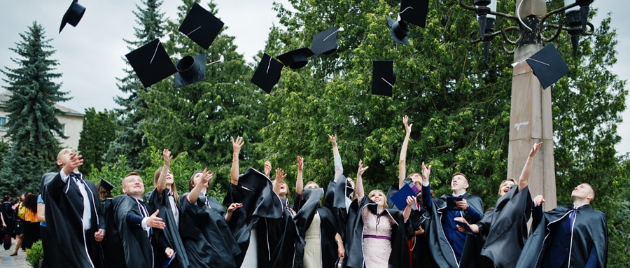 College students throwing caps after graduation ceremony