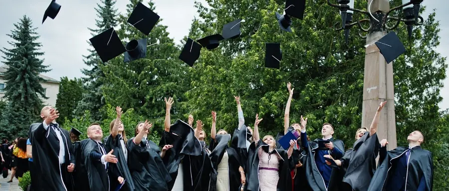 College students throwing caps after graduation ceremony