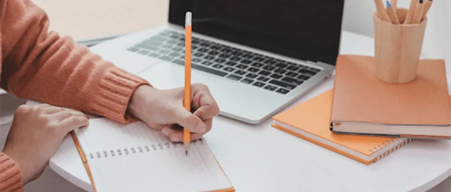 Person drafting her ideas on a notebook