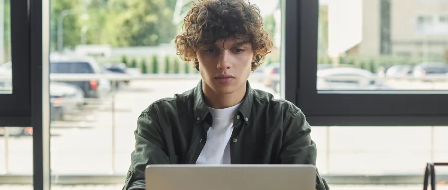 Student working on a laptop, symbolizing AI-driven admissions practices